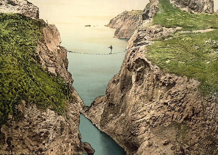 an image of a man crossing a mountain on a tight rope